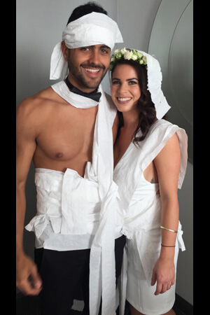 topless waiter with hen both wrapped in toilet paper dresses