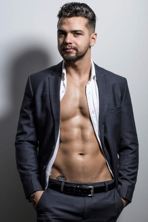 male life drawing model wearing a suit undone to the waist for a provocative start to a bachelorette live nude art class near auckland's kelston
