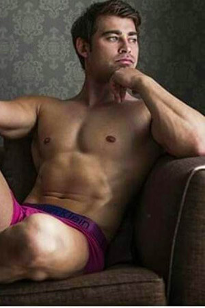 relaxed looking life drawing host posing in his undies on a couch near the eden terrace area of auckland