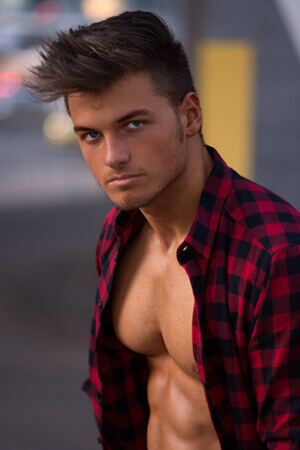 dark haired male art model for hens parties wearing open plaid shirt in christchurch's woolston