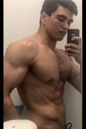 bachelorette party barman taking a topless selfie in the bathroom mirror