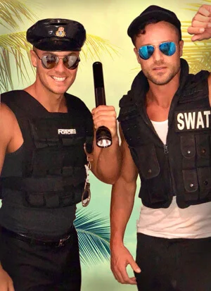Two male strippers in matching costumes for a double-act show