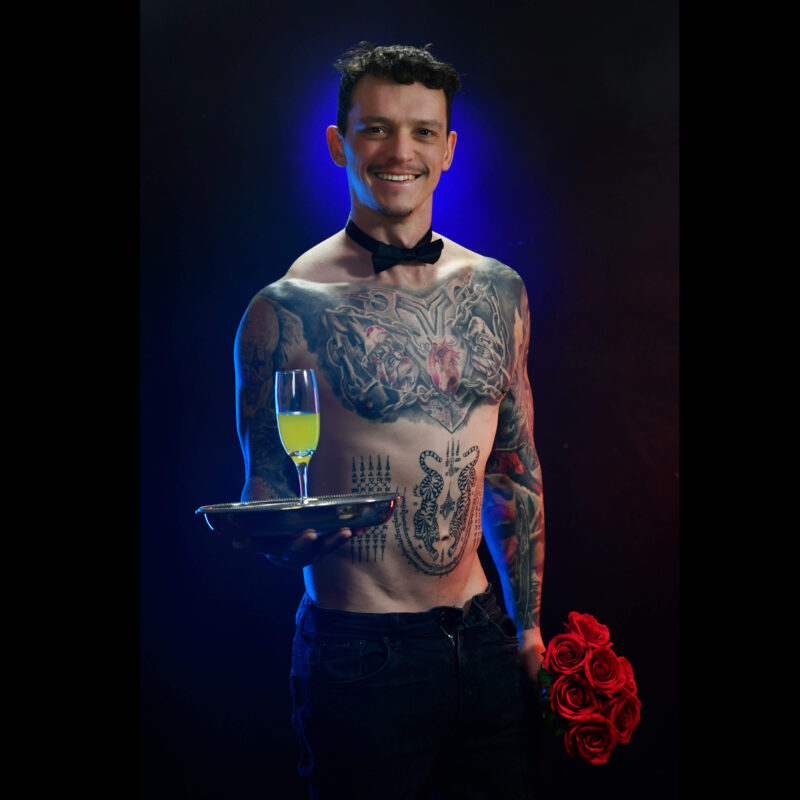 Topless waiter presenting champagne and flowers at a hens celebration